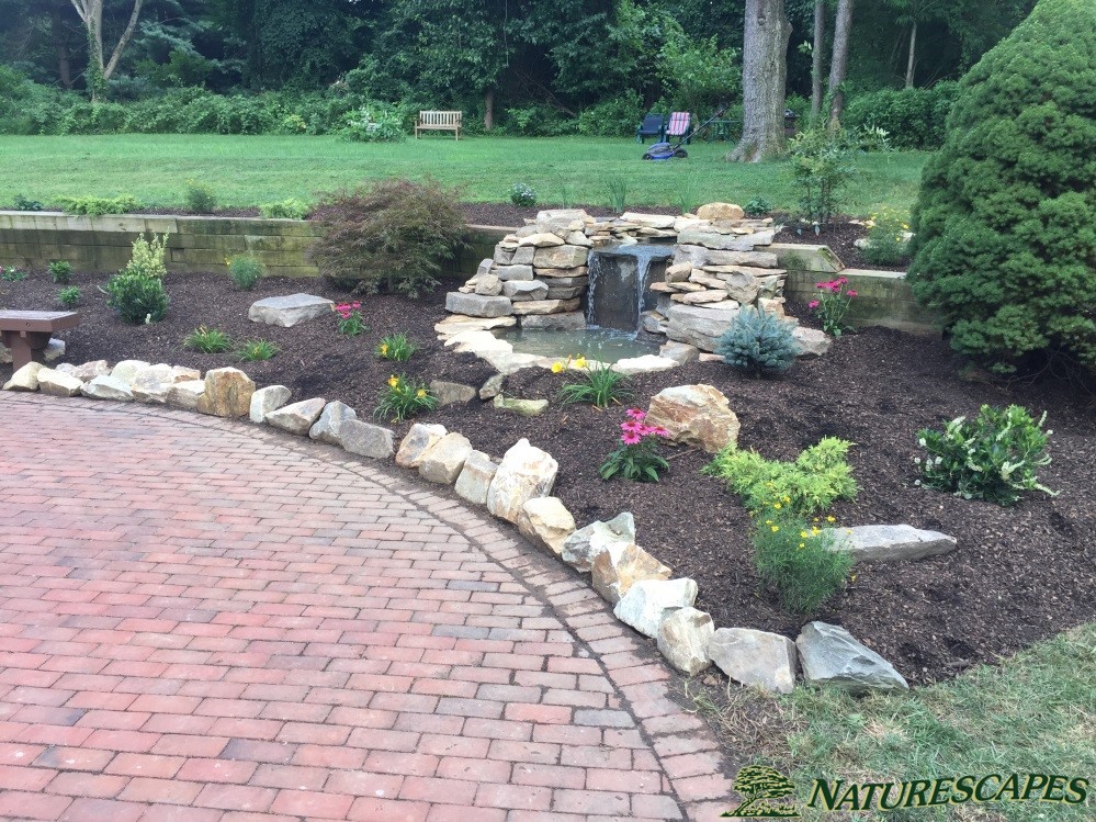 After updating the brick patio with boulderettes, perennials, and a water feature