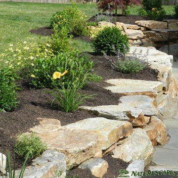 Retaining Wall with Boulders and Small Garden